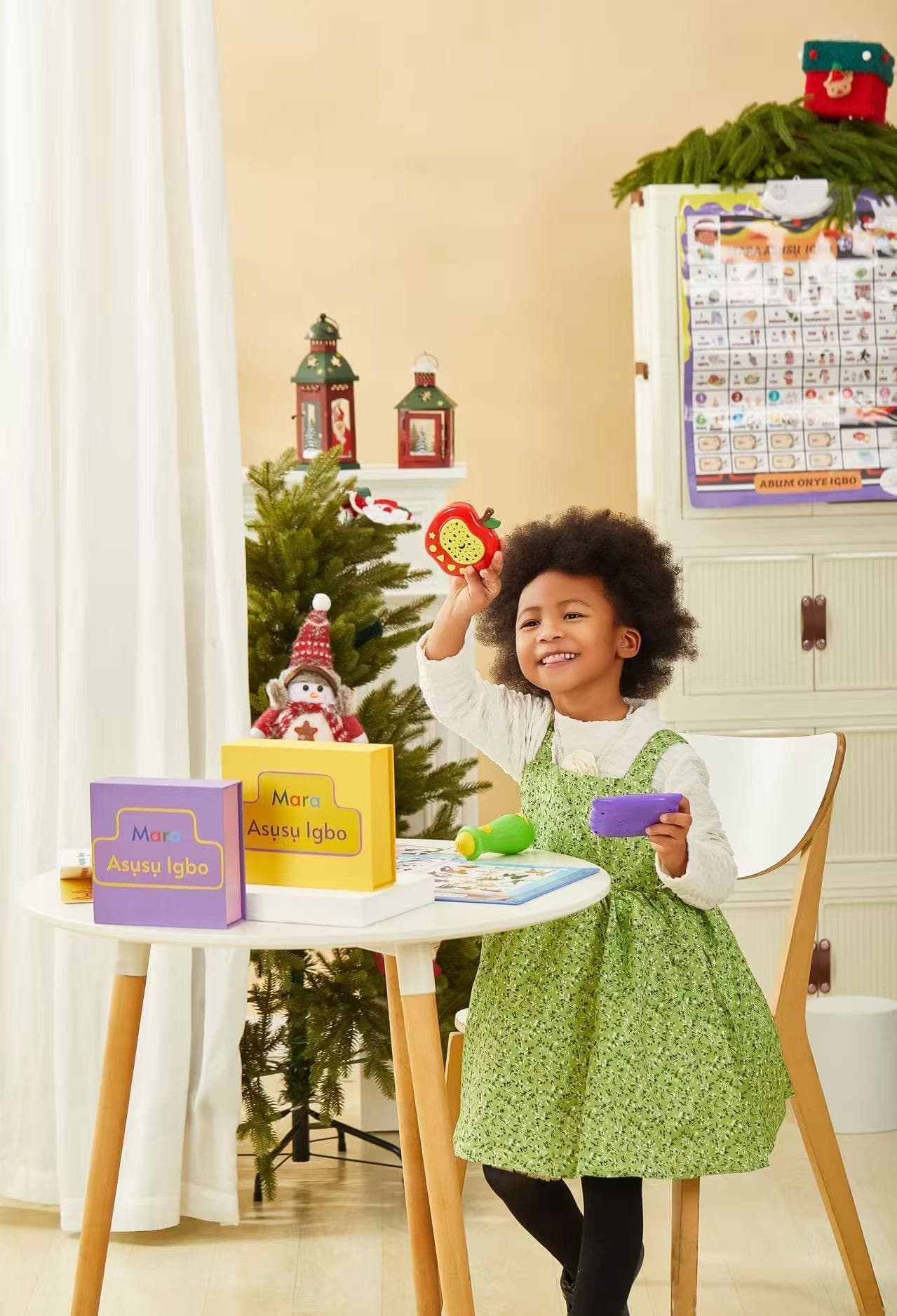 A child excitedly holding an AfriKidsLearn learning box